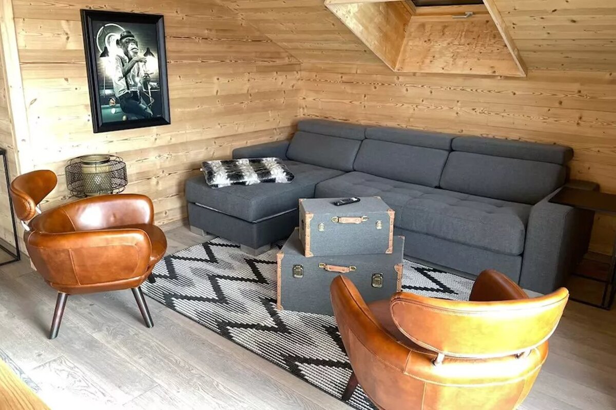 A living room with a couch and two chairs