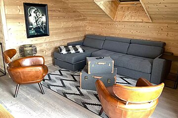 A living room with a couch and two chairs