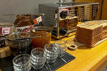 A table with a toaster and a jar of nutella