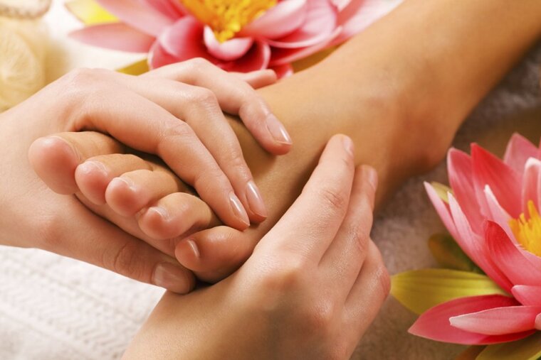 a person having their foot massaged
