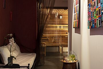 A room with a glass door leading to a sauna