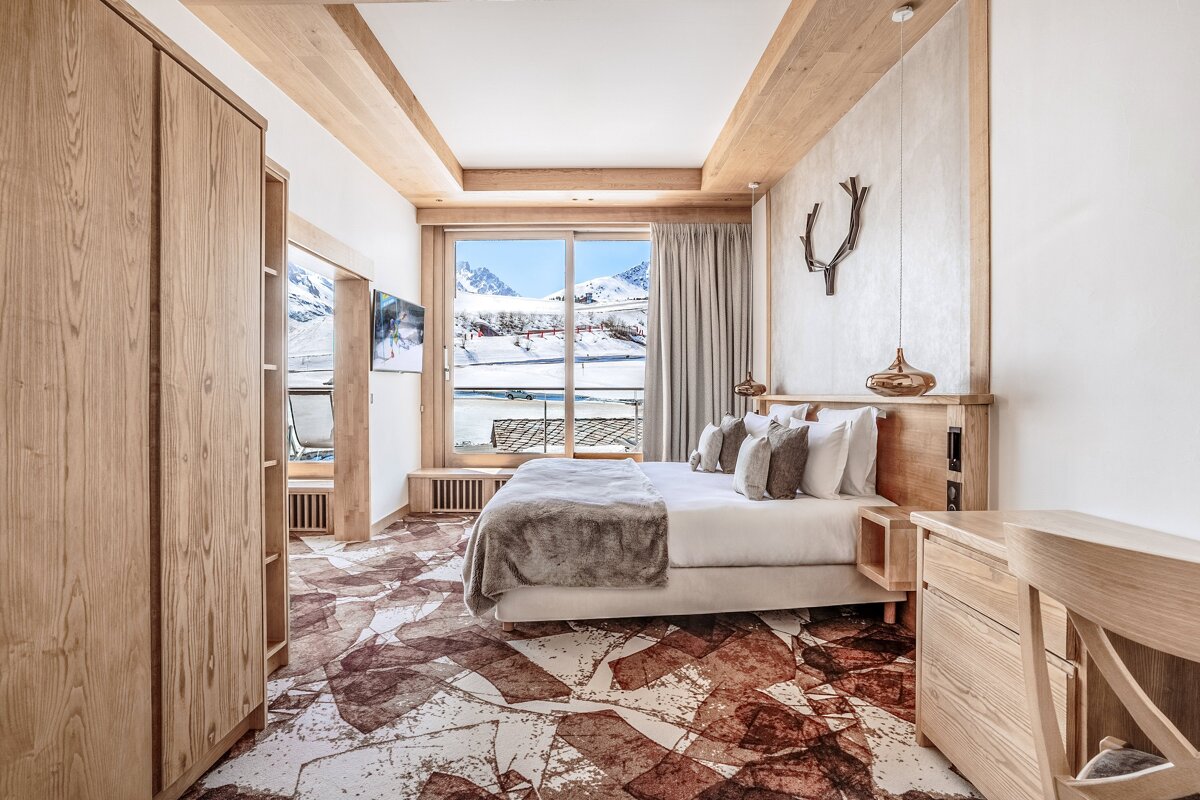 A bedroom with a large bed and a large window