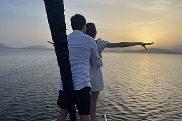 A man and a woman looking out over a body of water