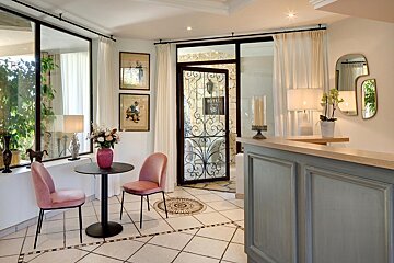 A room with a table and chairs and a sign that says hotel