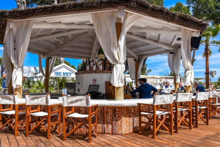 a bar with directors chairs around the edge