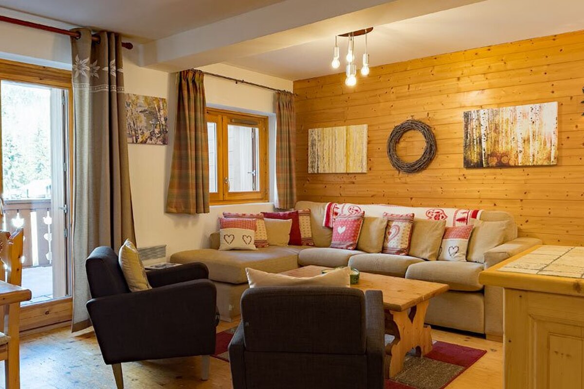 A living room with a couch and two chairs