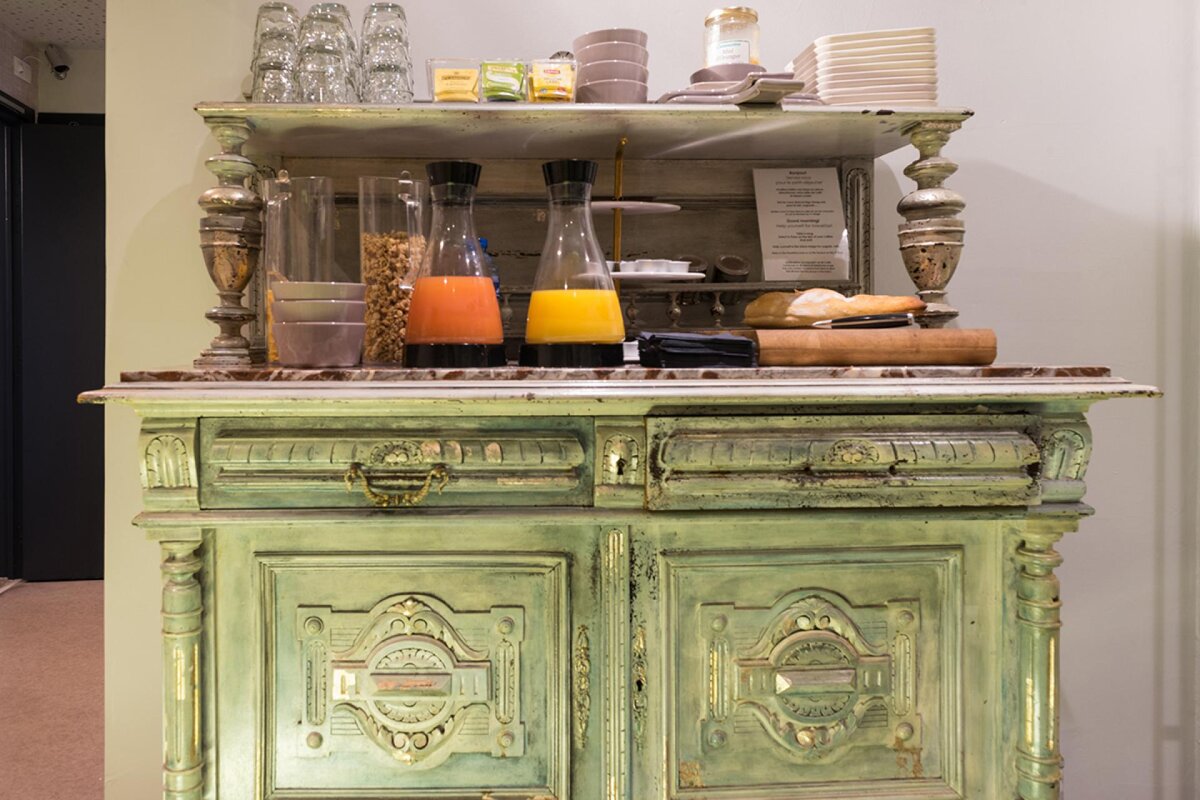 A green cabinet with a menu on top of it