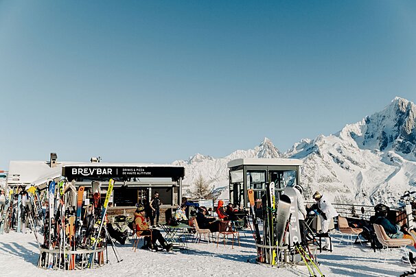 A group of people sit outside of a brew bar