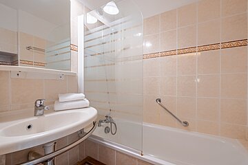 A bathroom with a sink and a bathtub