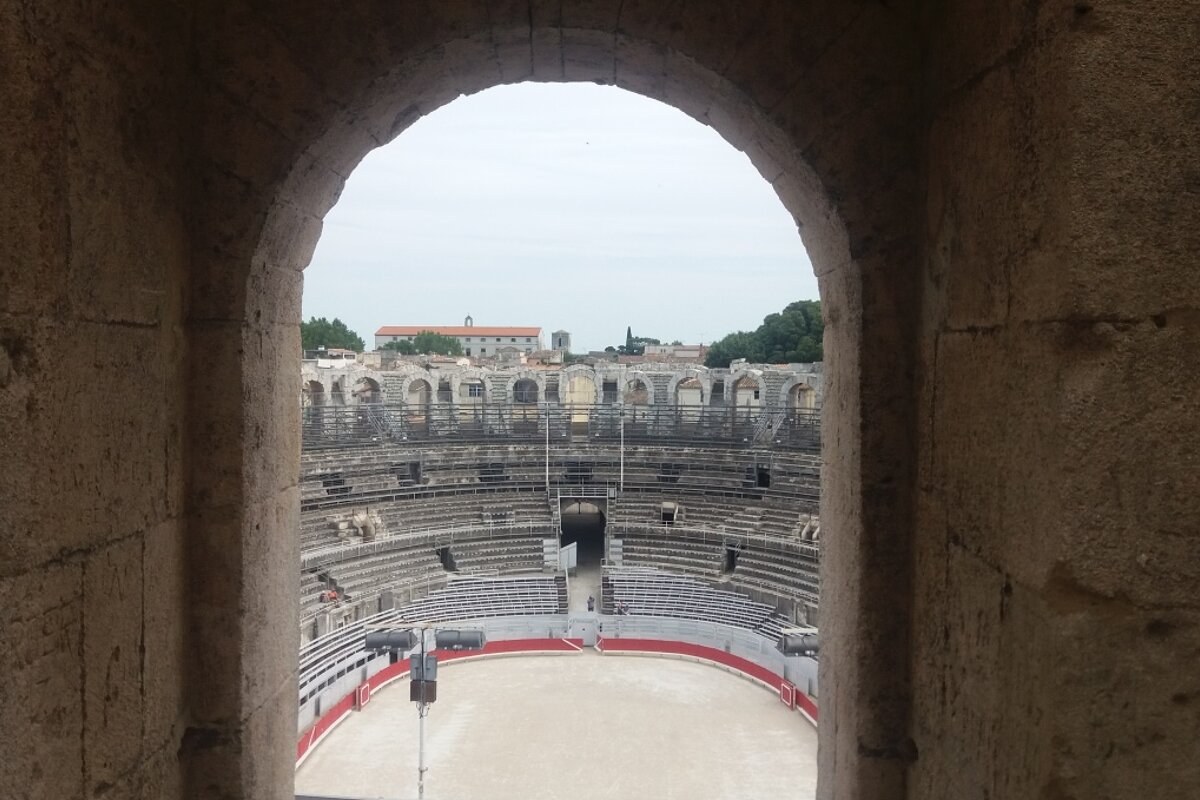 A view of an amphitheater through a stone archway