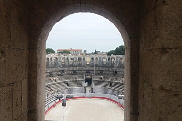 A view of an amphitheater through a stone archway