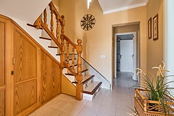 A wooden staircase leading up to the second floor of a house