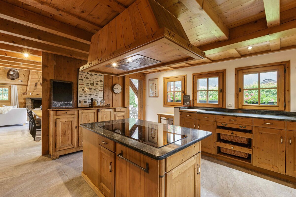 A kitchen with wooden cabinets and a stove top oven