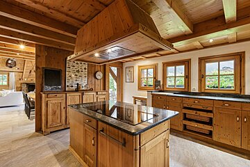 A kitchen with wooden cabinets and a stove top oven