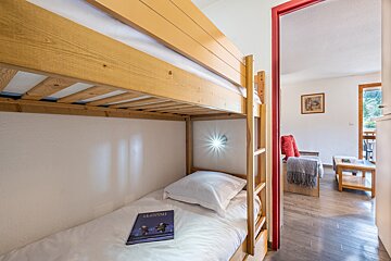 A bunk bed with a book on it that says augustine