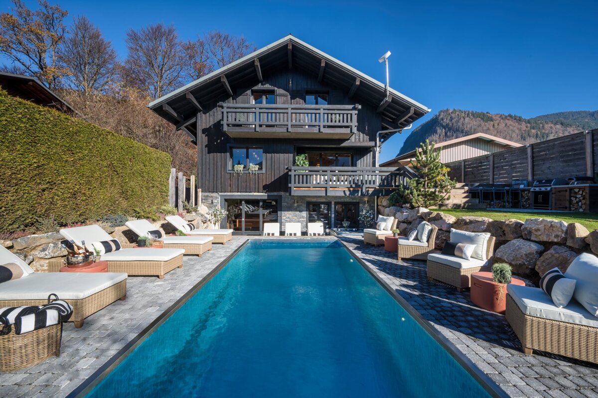 A large house with a swimming pool in front of it