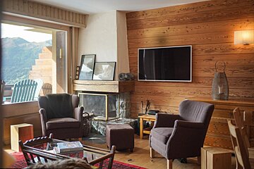 A living room with a fireplace and a flat screen tv