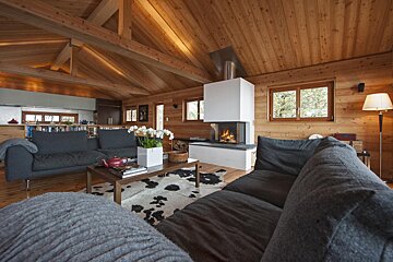 A living room with a couch a coffee table and a fireplace