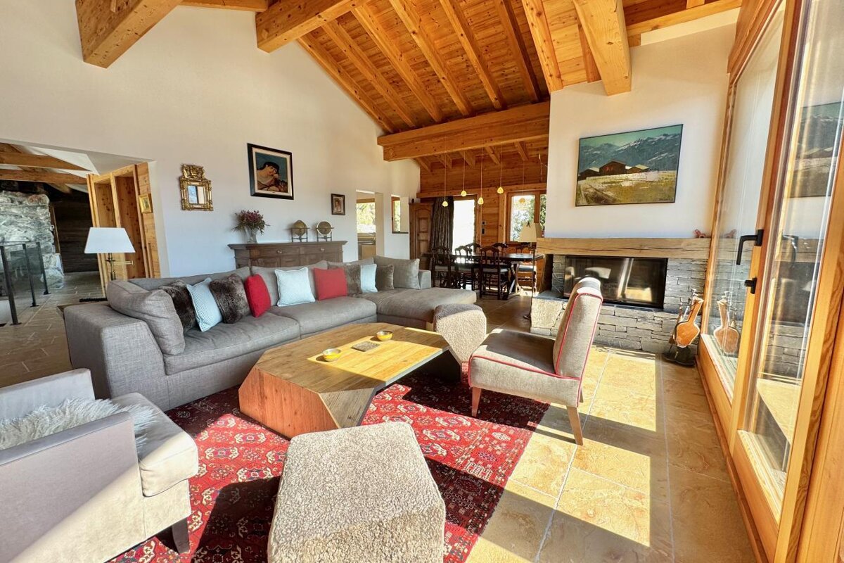 A living room with a couch and chairs and a fireplace