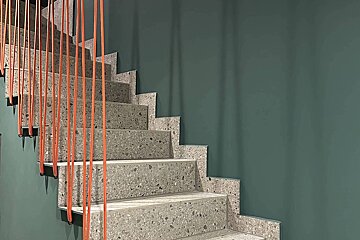 A set of stairs with a green wall behind them