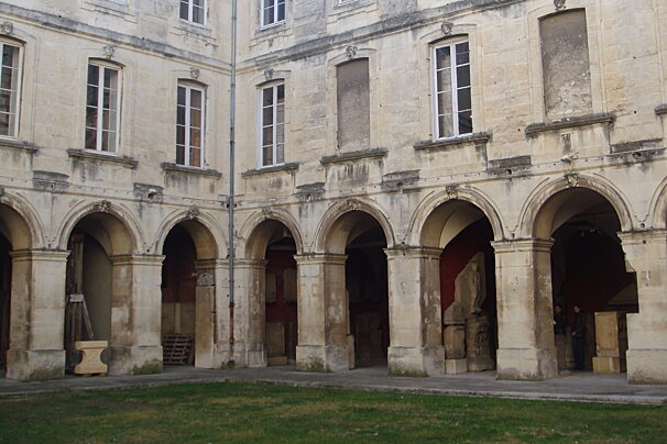 a courtyard and old building in nimes