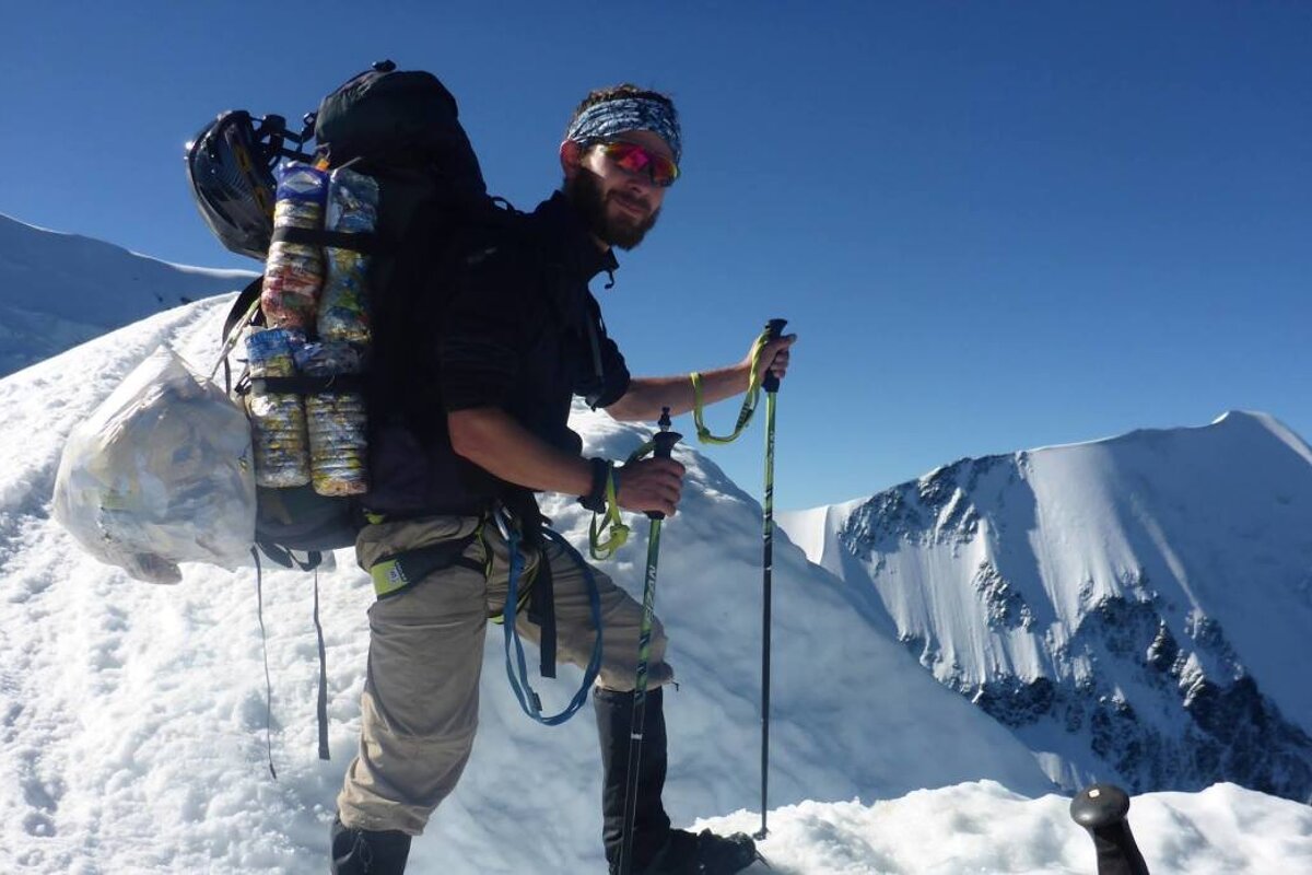german mountaineer with rubbish bags on mont blanc