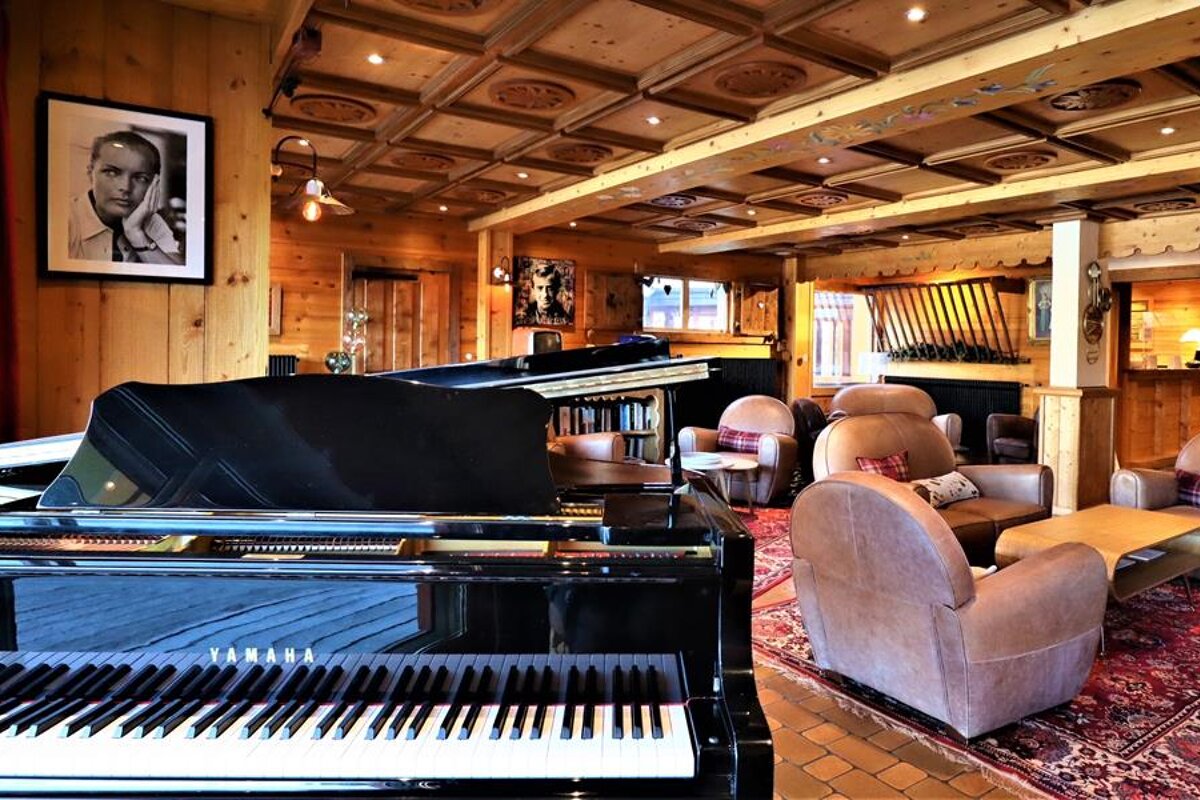 A yamaha grand piano sits in a living room