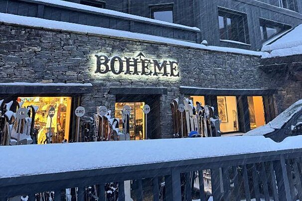 A snow-covered stone building with an illuminated