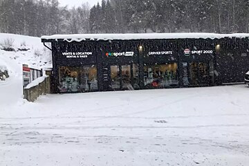 A snow-covered ski rental shop (