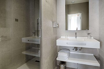 A bathroom with a sink and a mirror