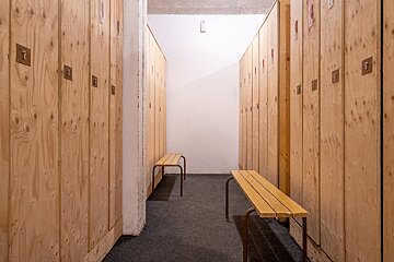 A row of wooden lockers with the number 1 on the door