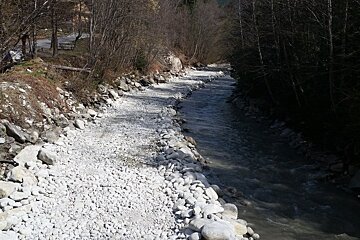 a river with debris piled up on one side