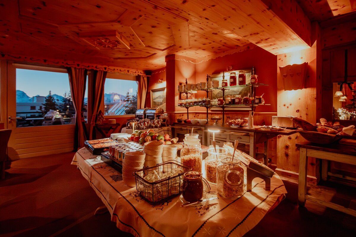 A buffet table with jars of cereal and fruit on it