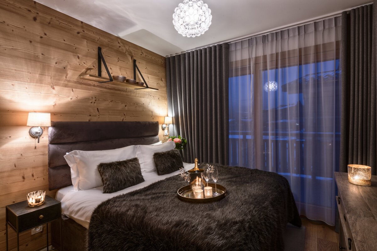 A bedroom with a bed and a tray of candles on it