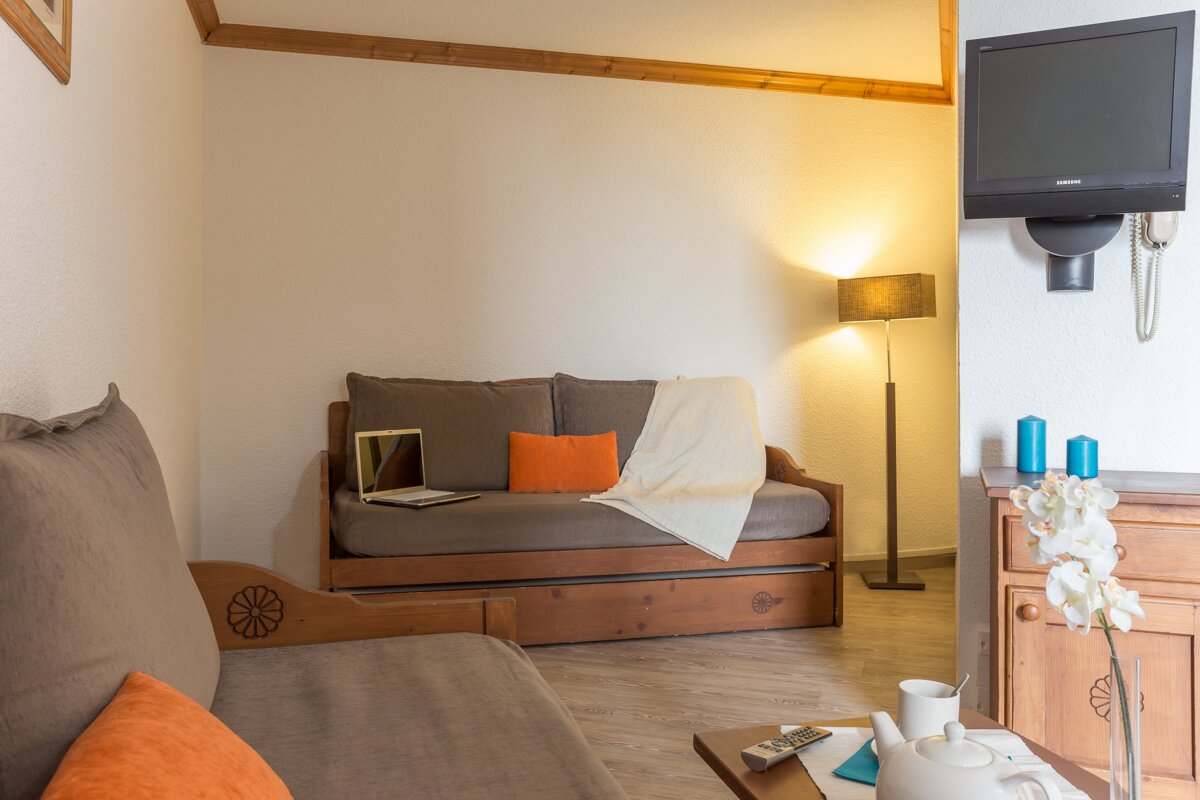 A living room with a couch and a flat screen tv