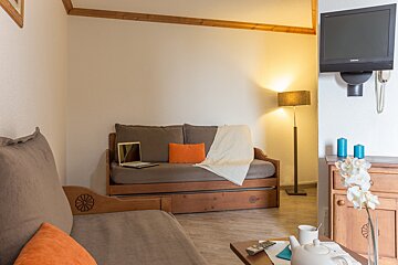 A living room with a couch and a flat screen tv