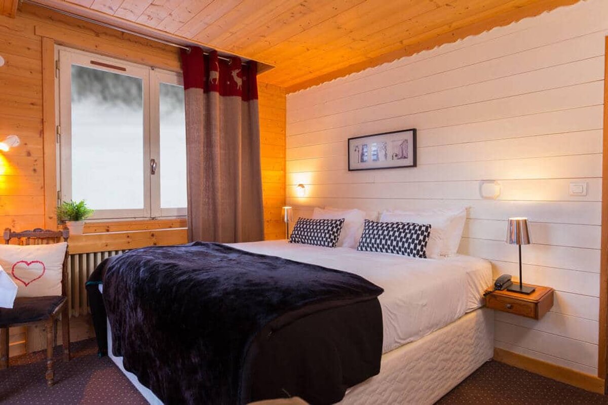 A bedroom with a bed and a picture on the wall