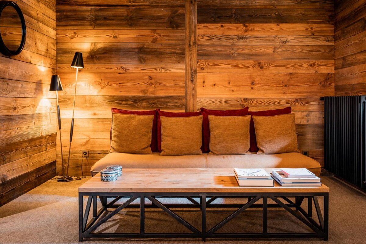 A wooden room with a couch and a coffee table