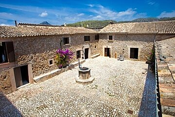 A stone courtyard with a well in the middle