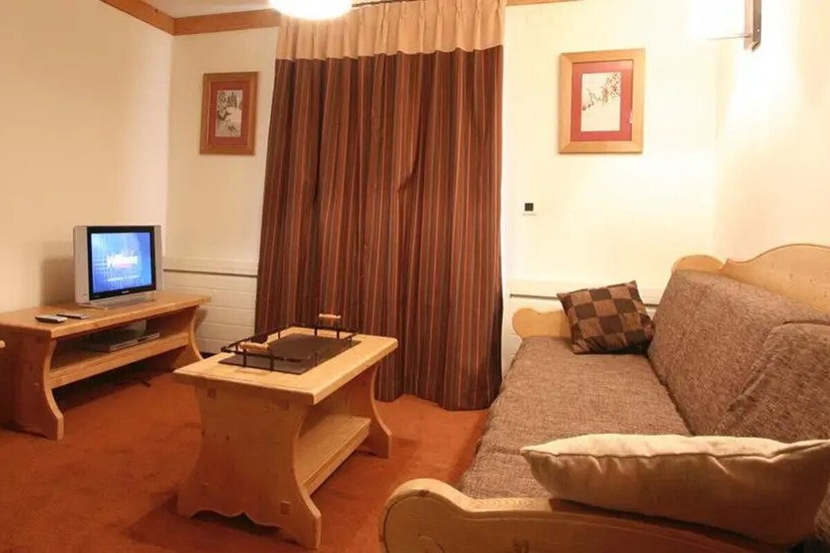 A living room with a couch and a television