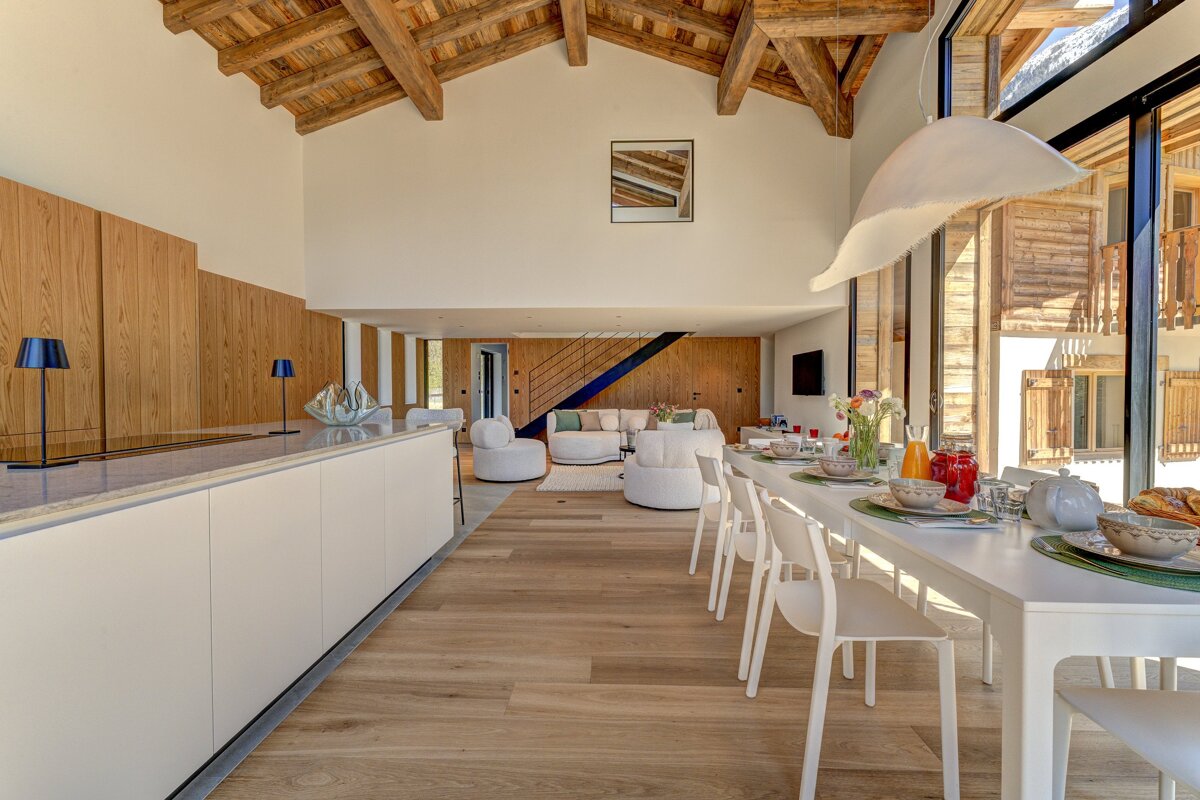 A living room with a dining table and chairs