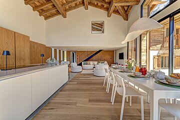 A living room with a dining table and chairs