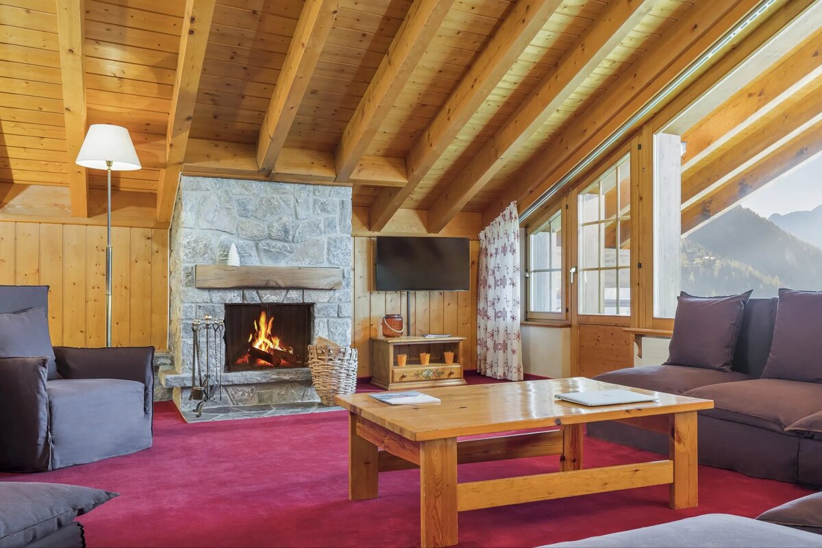 A living room with a fireplace and a flat screen tv