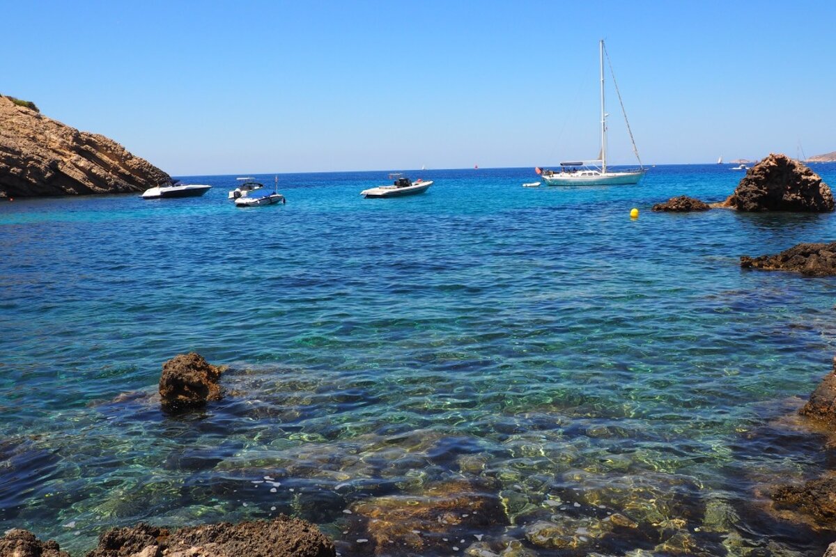view of the clear water and rocky seabed at cala moli