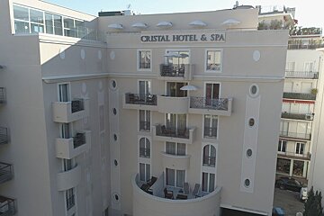 A white building with a sign that says cristal hotel & spa