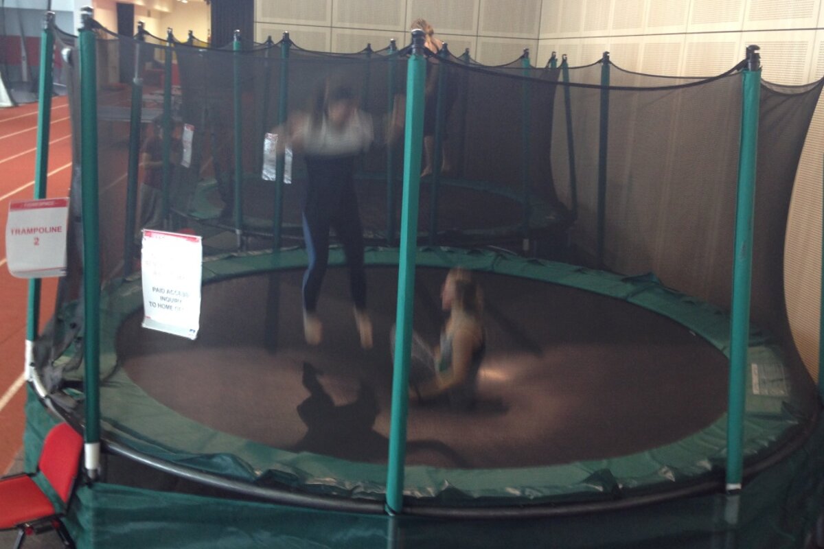 two people bouncing on the same trampoline