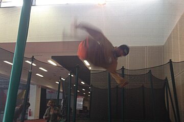 a man bouncing upside down on a trampoline