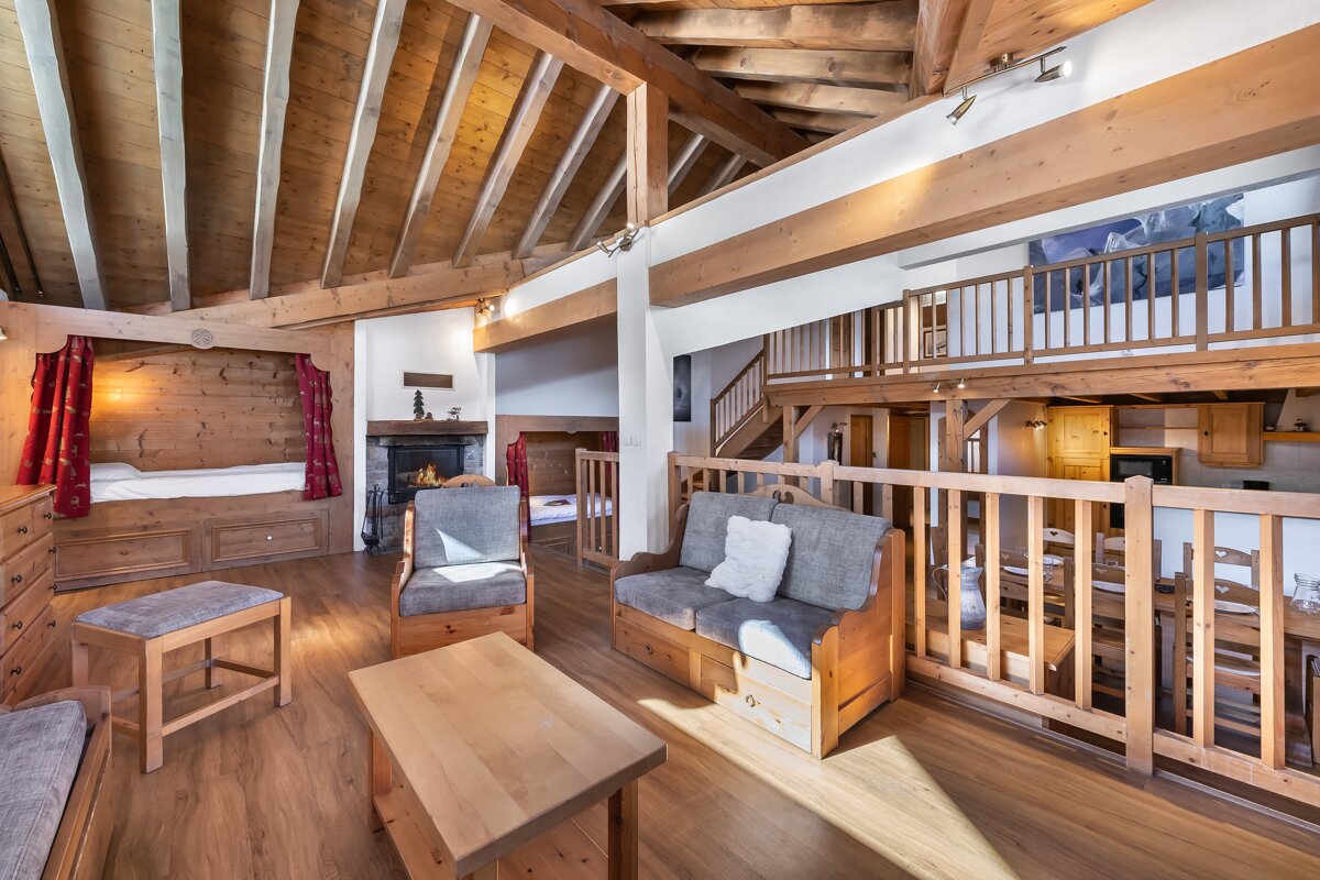 A living room with wooden furniture and a fireplace