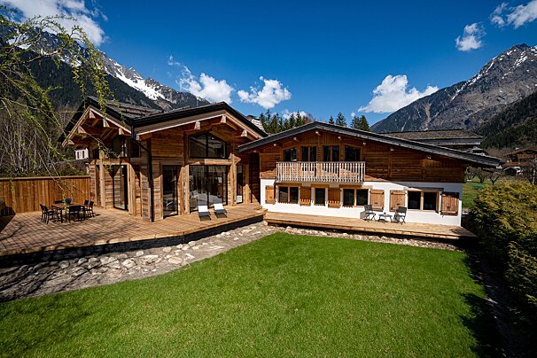 A large house with a large lawn in front of it