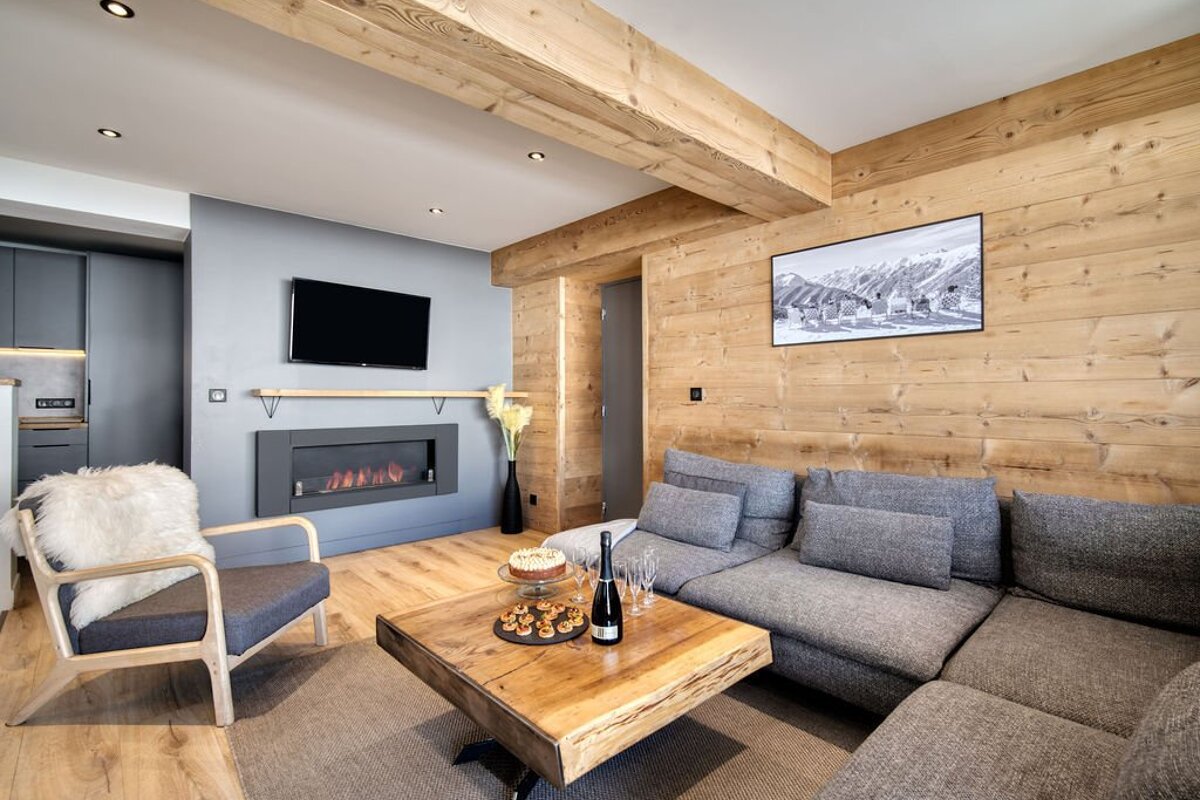 A living room with a couch a chair and a fireplace